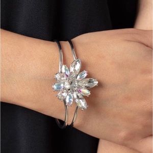 Bracelet, looks like a bangle, featuring a hinged closure.